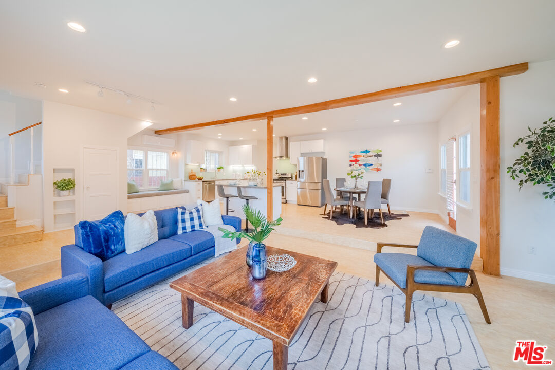 1251 South Muirfield Road Los Angeles, CA 90019 - Photo 5 of 24 a living room with furniture wooden floor and a table