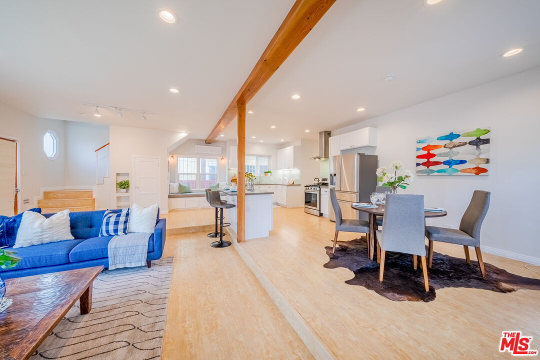1251 South Muirfield Road Los Angeles, CA 90019 - Photo 6 of 24 a dining room with furniture and a floor to ceiling window