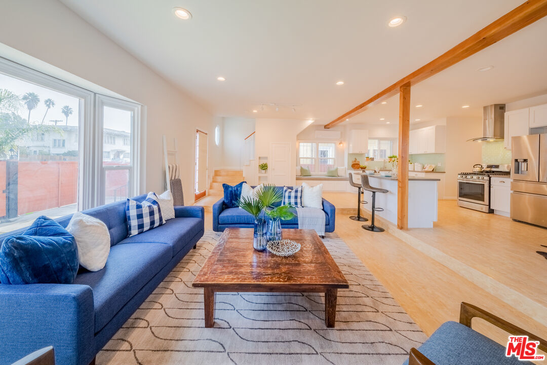 1251 South Muirfield Road Los Angeles, CA 90019 - Photo 7 of 24 a living room with furniture kitchen view and a large window