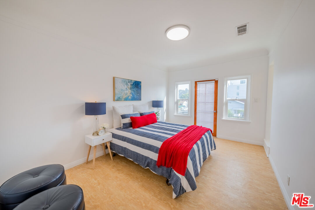 1251 South Muirfield Road Los Angeles, CA 90019 - Photo 10 of 24 a bedroom with a bed and window