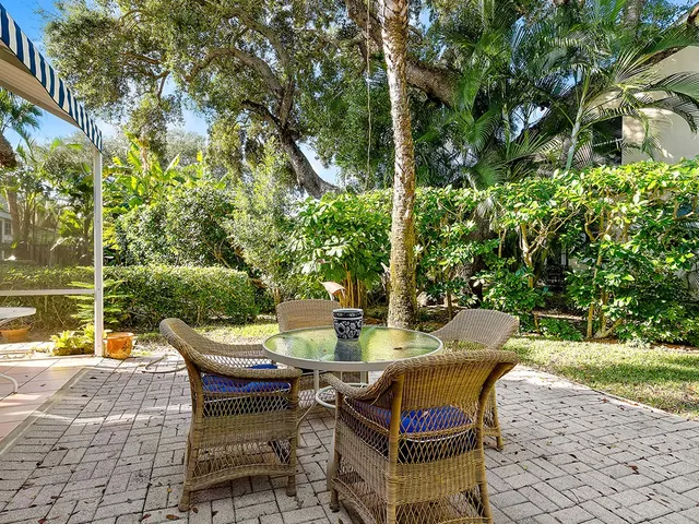 a view of a patio with table and chairs and potted plants