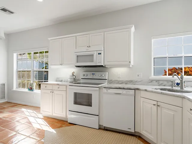 a kitchen with stainless steel appliances granite countertop a stove sink and cabinets