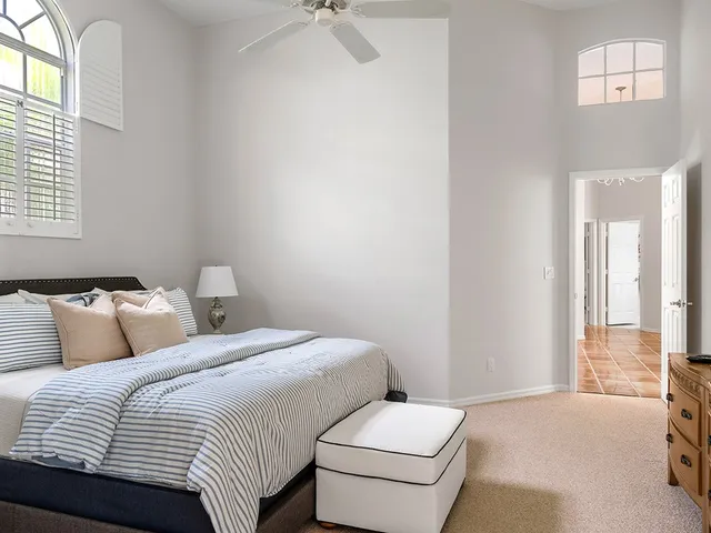 a bathroom with a granite countertop sink a mirror and shower