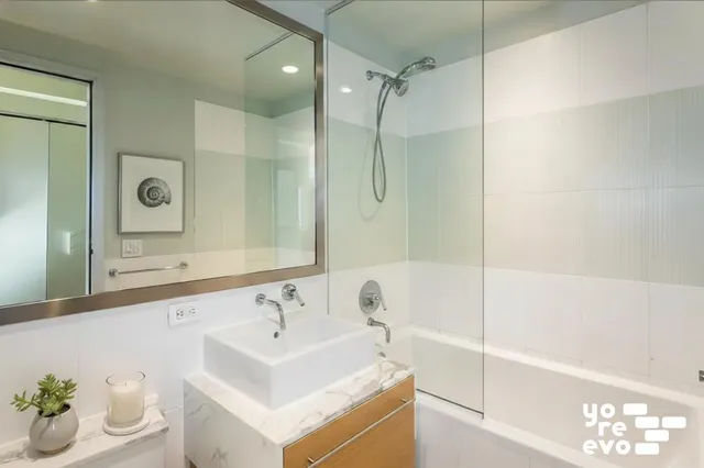 a bathroom with a sink toilet vanity and tub