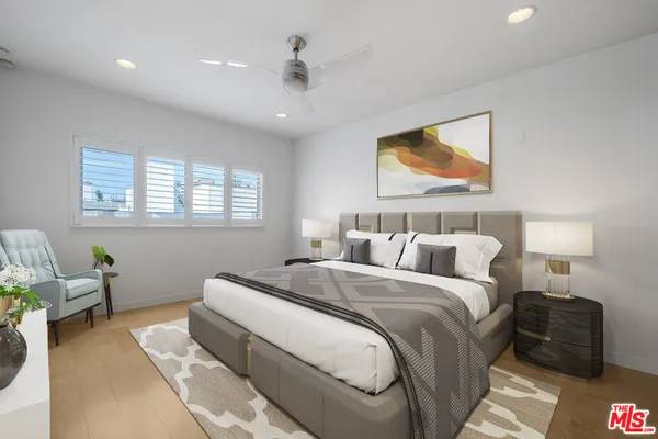 a spacious bedroom with a bed and furniture