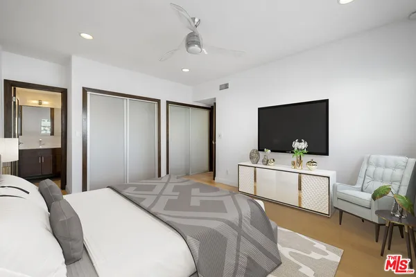 a bedroom with a bed and a flat screen tv