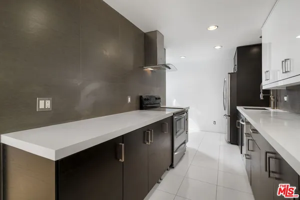 a kitchen with a sink and a refrigerator