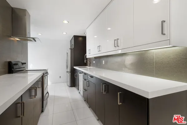 a kitchen with a sink appliances and cabinets