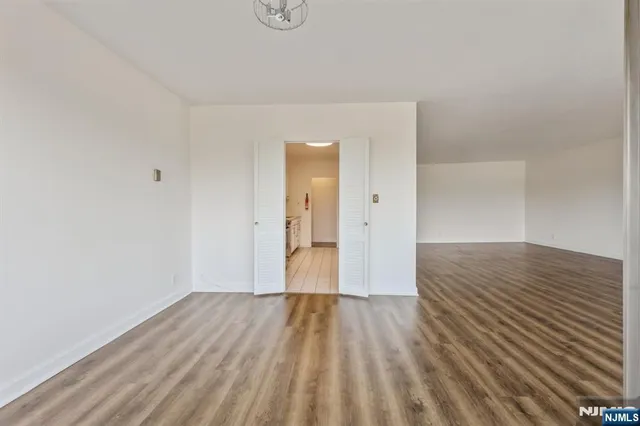 a kitchen with stainless steel appliances a stove top oven a sink and a refrigerator