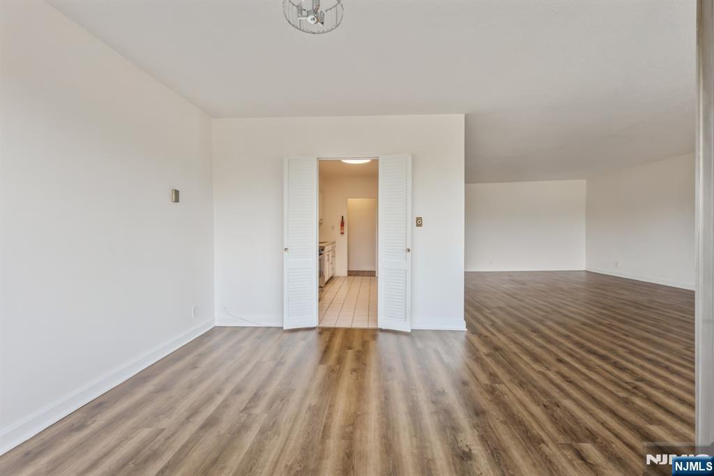 6 Horizon Road, Unit 310 Fort Lee, NJ 07024 - Photo 16 of 35 a view of a room with wooden floor and bench