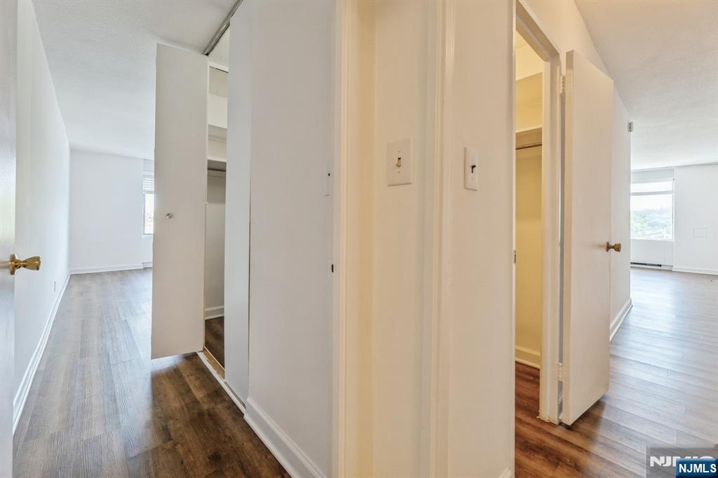 6 Horizon Road, Unit 310 Fort Lee, NJ 07024 - Photo 20 of 35 a view of a hallway with wooden floor and staircase