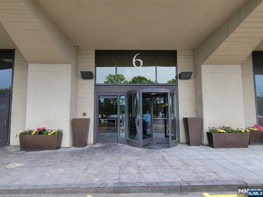 6 Horizon Road, Unit 310 Fort Lee, NJ 07024 - Photo 2 of 35 a living room with furniture and a potted plant