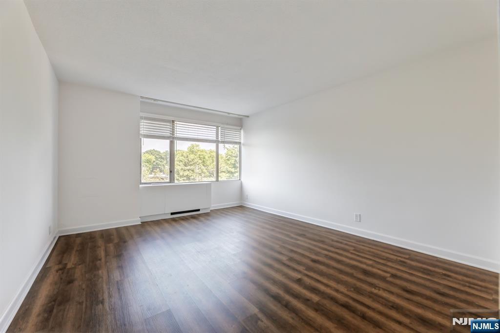 6 Horizon Road, Unit 310 Fort Lee, NJ 07024 - Photo 24 of 35 an empty room with wooden floor and windows