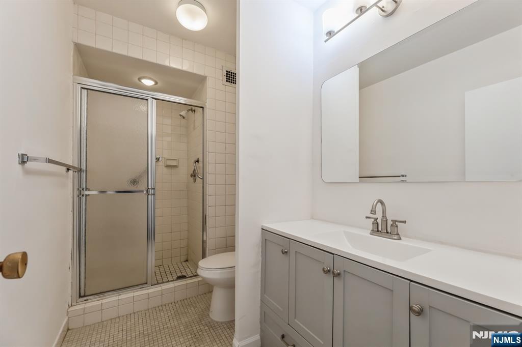 6 Horizon Road, Unit 310 Fort Lee, NJ 07024 - Photo 29 of 35 a bathroom with a sink a toilet and shower