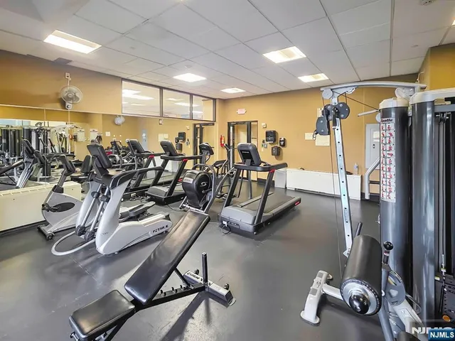 a living room with stainless steel appliances kitchen island granite countertop furniture a rug and a window