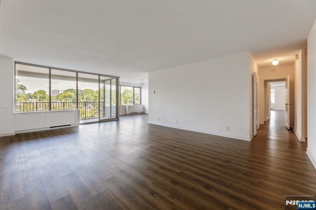 6 Horizon Road, Unit 310 Fort Lee, NJ 07024 - Photo 7 of 35 a view of an empty room with wooden floor and a window