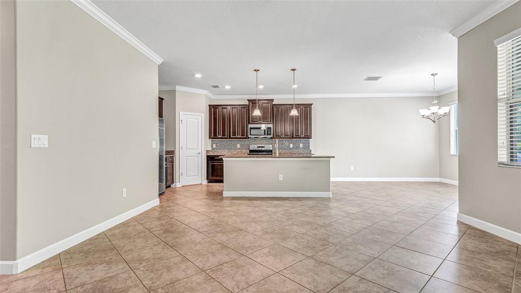 1695 Ludington Avenue Wesley Chapel, FL 33543 - Photo 20 of 65 a view of kitchen with kitchen island stainless steel appliances a refrigerator sink and cabinets