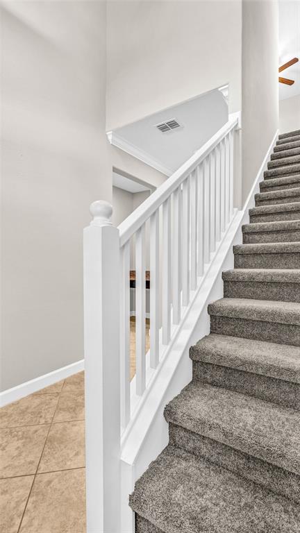 1695 Ludington Avenue Wesley Chapel, FL 33543 - Photo 21 of 65 a view of staircase with lots of frames on wall and a rug