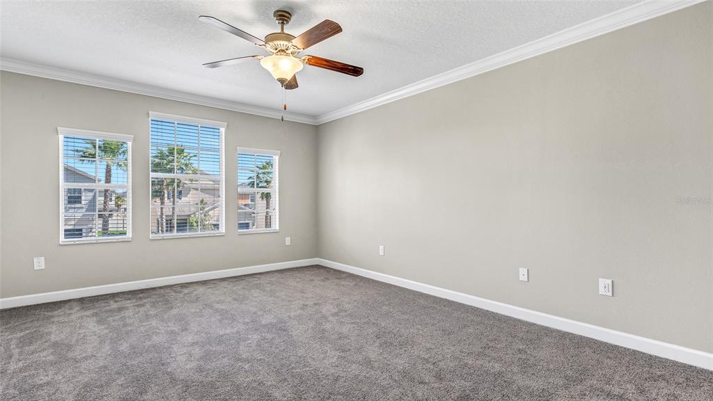 1695 Ludington Avenue Wesley Chapel, FL 33543 - Photo 24 of 65 an empty room with a window and a fan