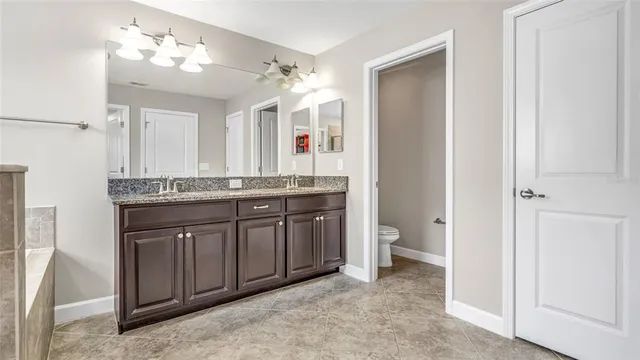 an empty room with closet and fan