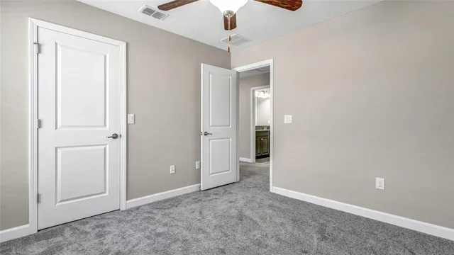 a view of a livingroom with furniture and a ceiling fan