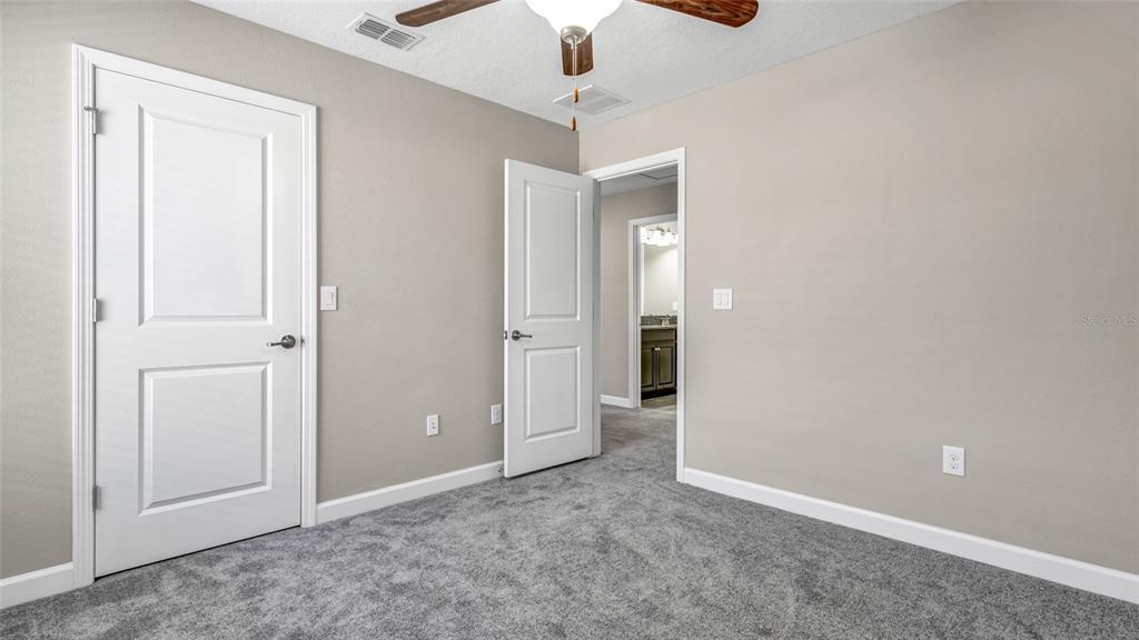 1695 Ludington Avenue Wesley Chapel, FL 33543 - Photo 34 of 65 an empty room with closet and fan