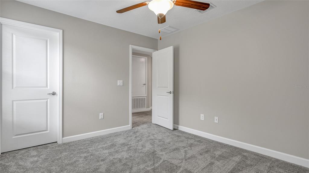 1695 Ludington Avenue Wesley Chapel, FL 33543 - Photo 36 of 65 an empty room with hallway fan
