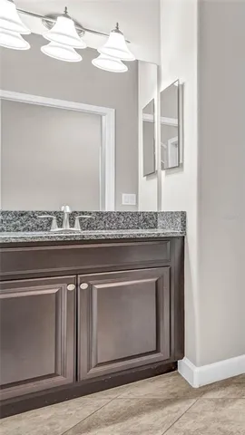 a view of kitchen with stainless steel appliances granite countertop a stove top oven a sink dishwasher and a refrigerator with wooden floor