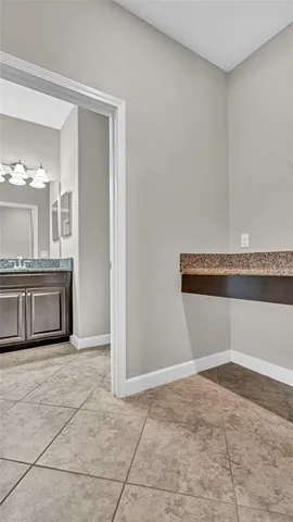 a view of kitchen with refrigerator and microwave