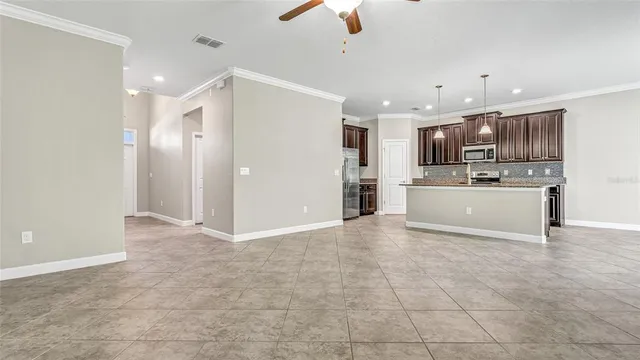 a kitchen with stainless steel appliances granite countertop a sink a stove and a refrigerator
