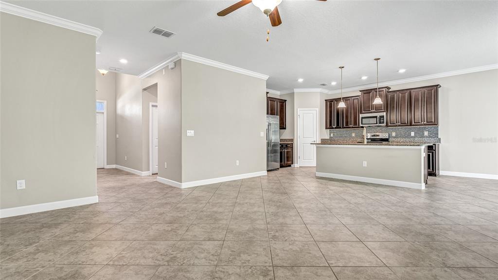 1695 Ludington Avenue Wesley Chapel, FL 33543 - Photo 10 of 65 a view of kitchen with refrigerator and microwave