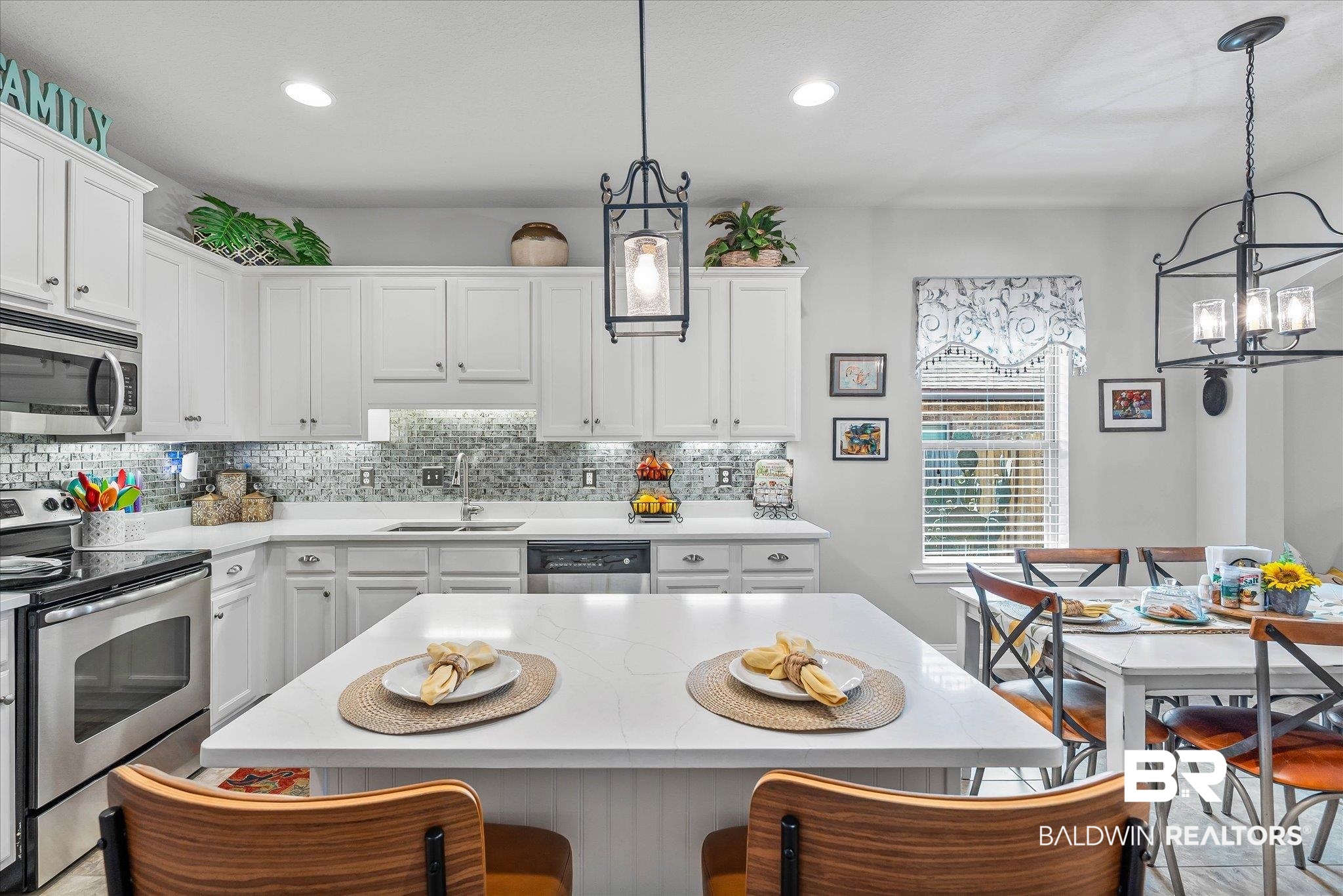 10677 Orkney Way Spanish Fort, AL 36527 - Photo 7 of 22 Kitchen featuring stainless steel appliances, a kitchen island, tasteful backsplash, white cabinets, and recessed lighting