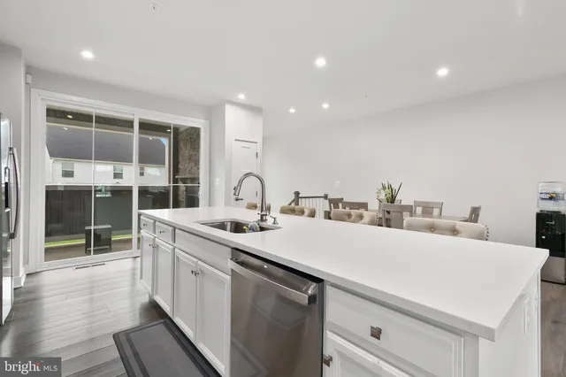 a kitchen with microwave a sink cabinets and wooden floor