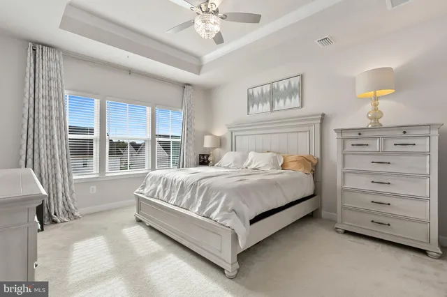 a bedroom with two beds and a baby crib