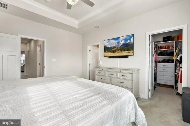 a bedroom with a bed and a lamp on a table