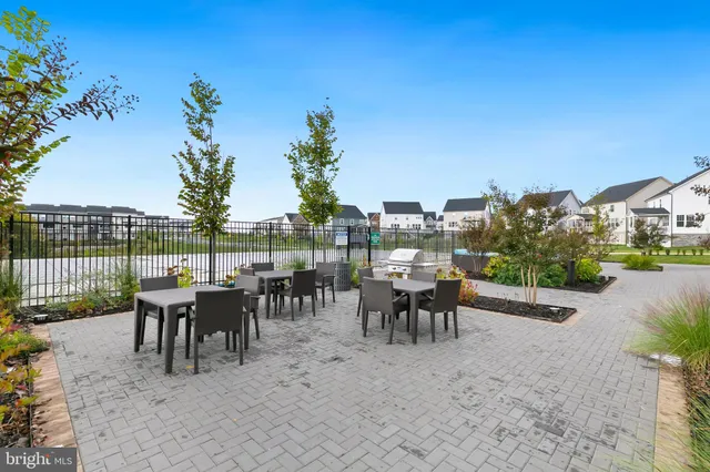 a front view of a house with a yard and outdoor seating