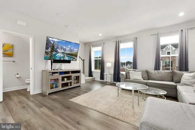 a living room with furniture and kitchen view with kitchen view