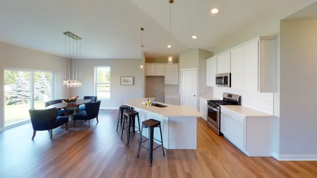 a living room with furniture a wooden floor and a window
