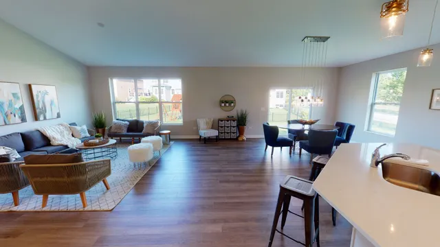 a living room with fireplace furniture and a wooden floor