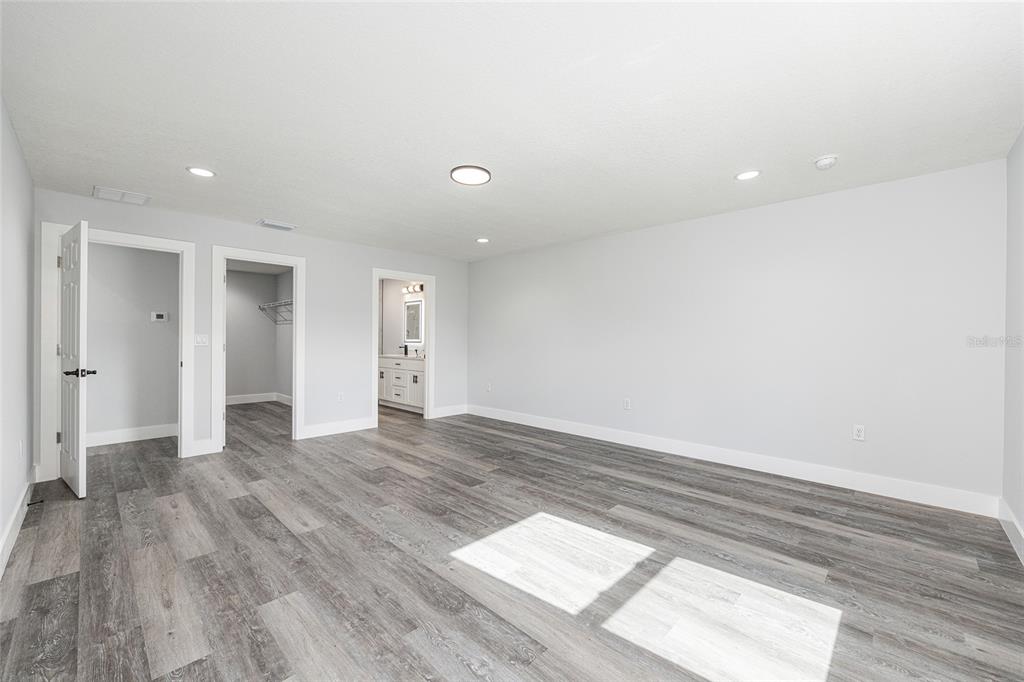 3244 Southeast 147th Lane Summerfield, FL 34491 - Photo 12 of 25 a view of an empty room and wooden floor