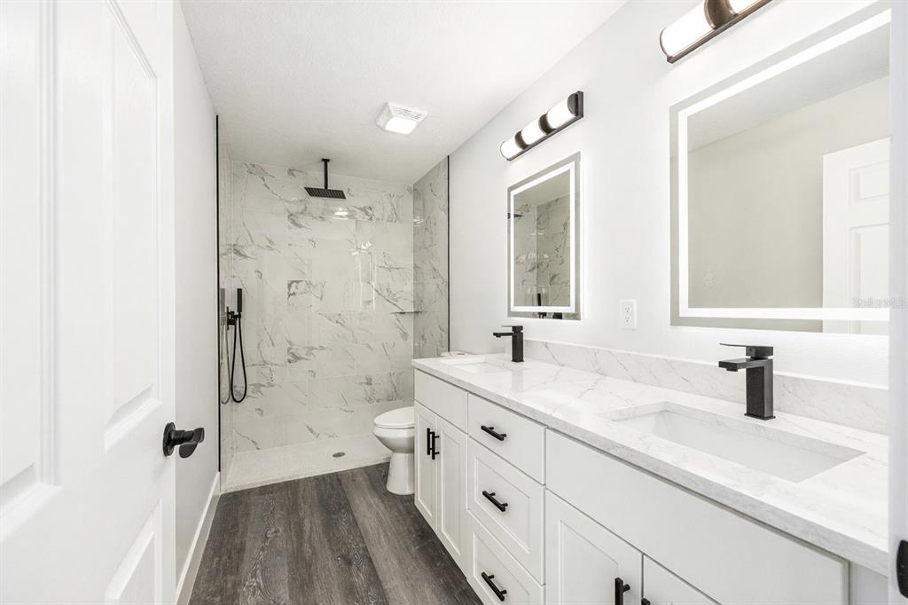 3244 Southeast 147th Lane Summerfield, FL 34491 - Photo 14 of 25 a bathroom with a sink a toilet and shower