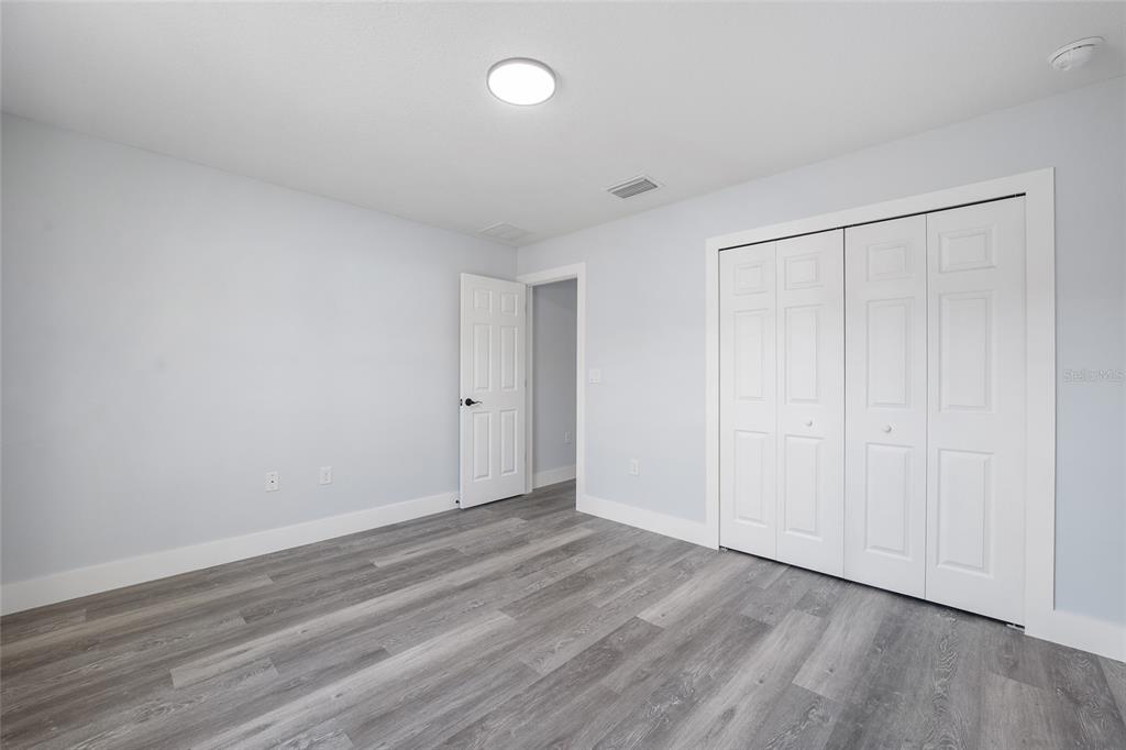 3244 Southeast 147th Lane Summerfield, FL 34491 - Photo 20 of 25 a view of an empty room with wooden floor and a window