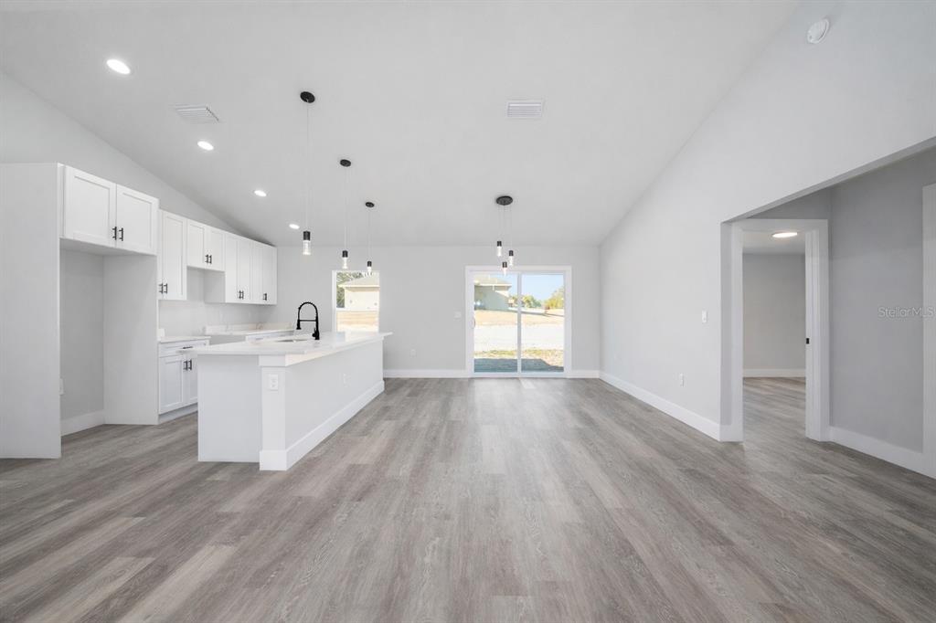 3244 Southeast 147th Lane Summerfield, FL 34491 - Photo 4 of 25 a view of a kitchen with wooden floor and windows