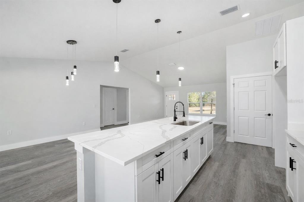 3244 Southeast 147th Lane Summerfield, FL 34491 - Photo 8 of 25 a large white room with a large mirror and sink