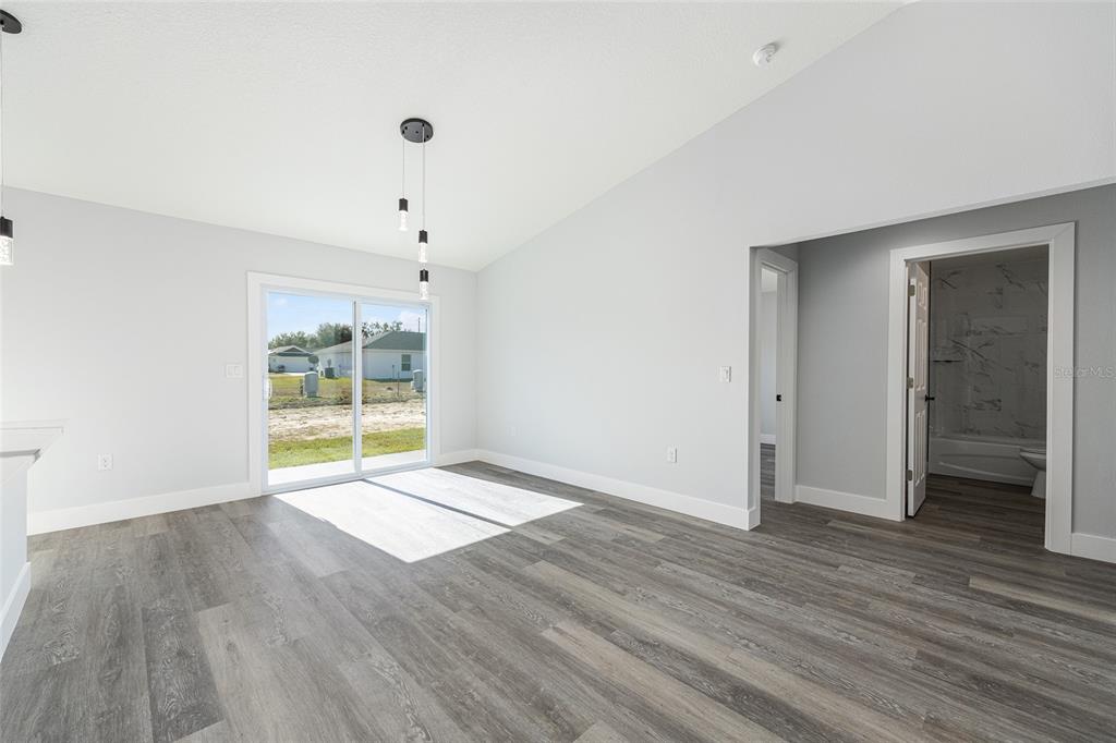 3244 Southeast 147th Lane Summerfield, FL 34491 - Photo 10 of 25 a view of an empty room with wooden floor and a window