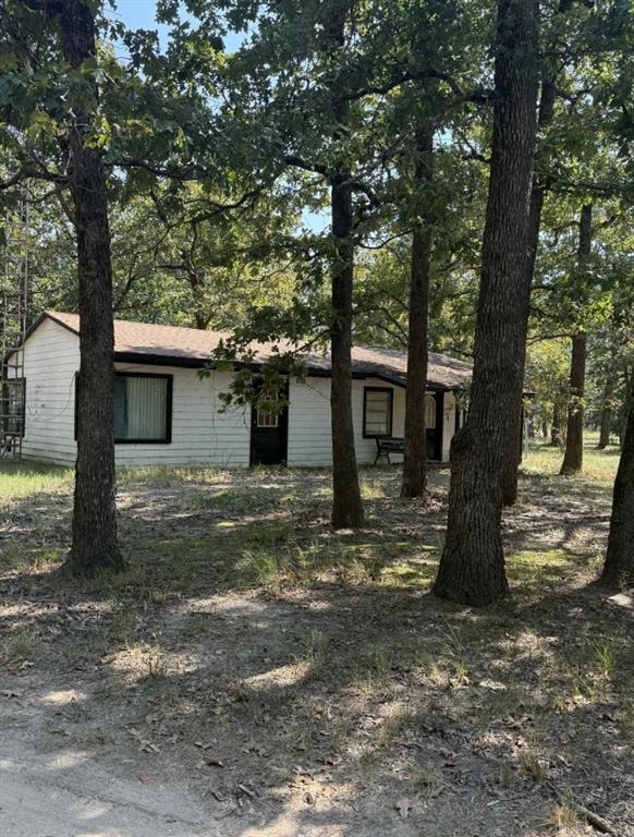 a view of a house with a tree in the background