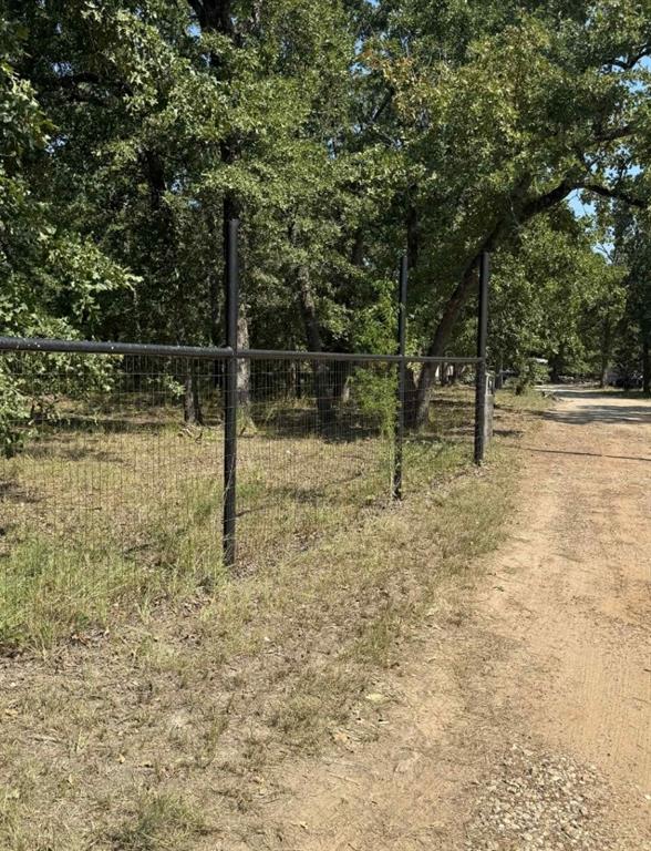 928 County Road 1660 Alba, TX 75410 - Photo 5 of 17 a view of a yard with wooden fence