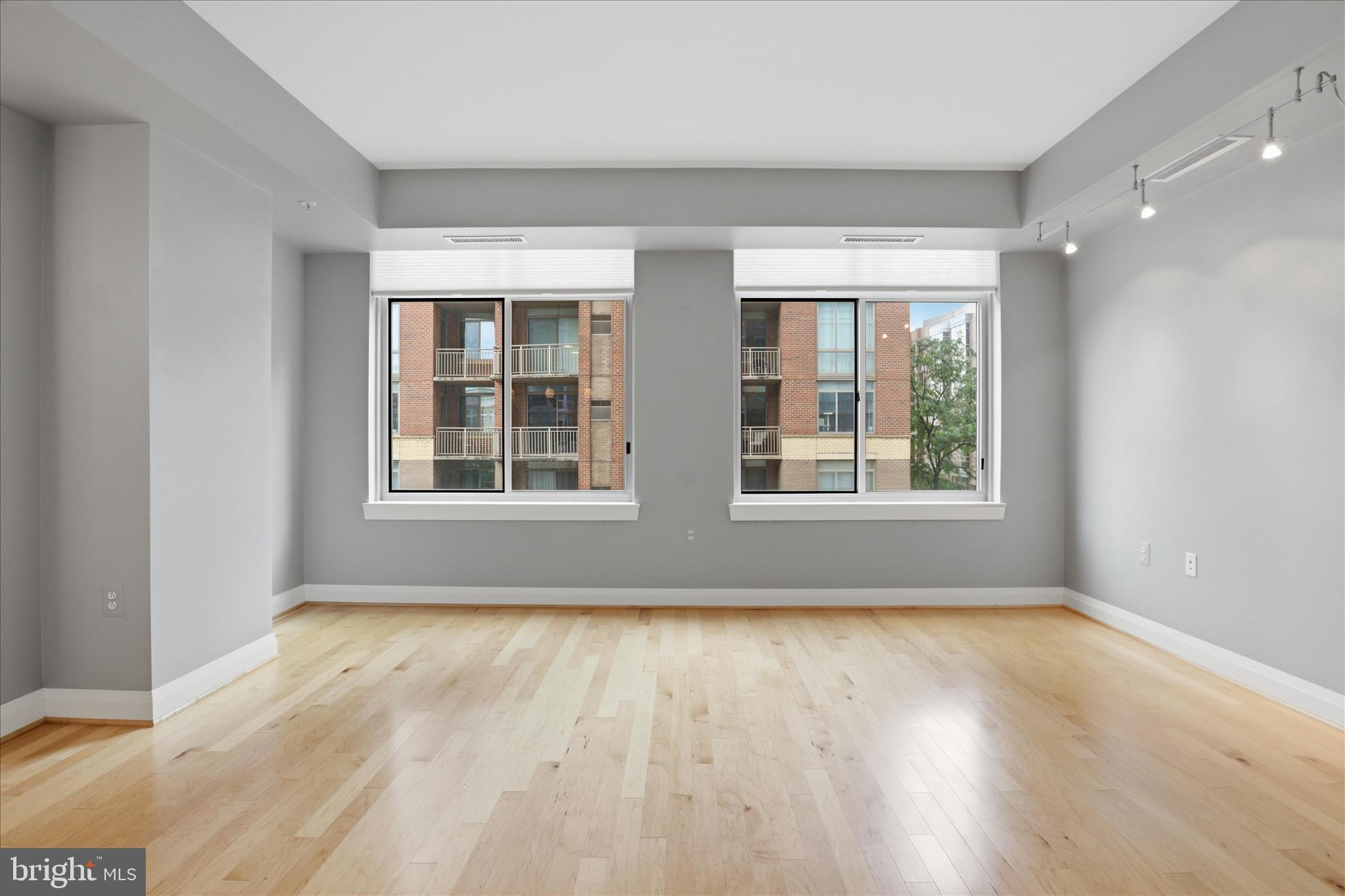 11990 Market Street, Unit 216 Reston, VA 20190 - Photo 16 of 41 a view of an empty room with wooden floor and a window