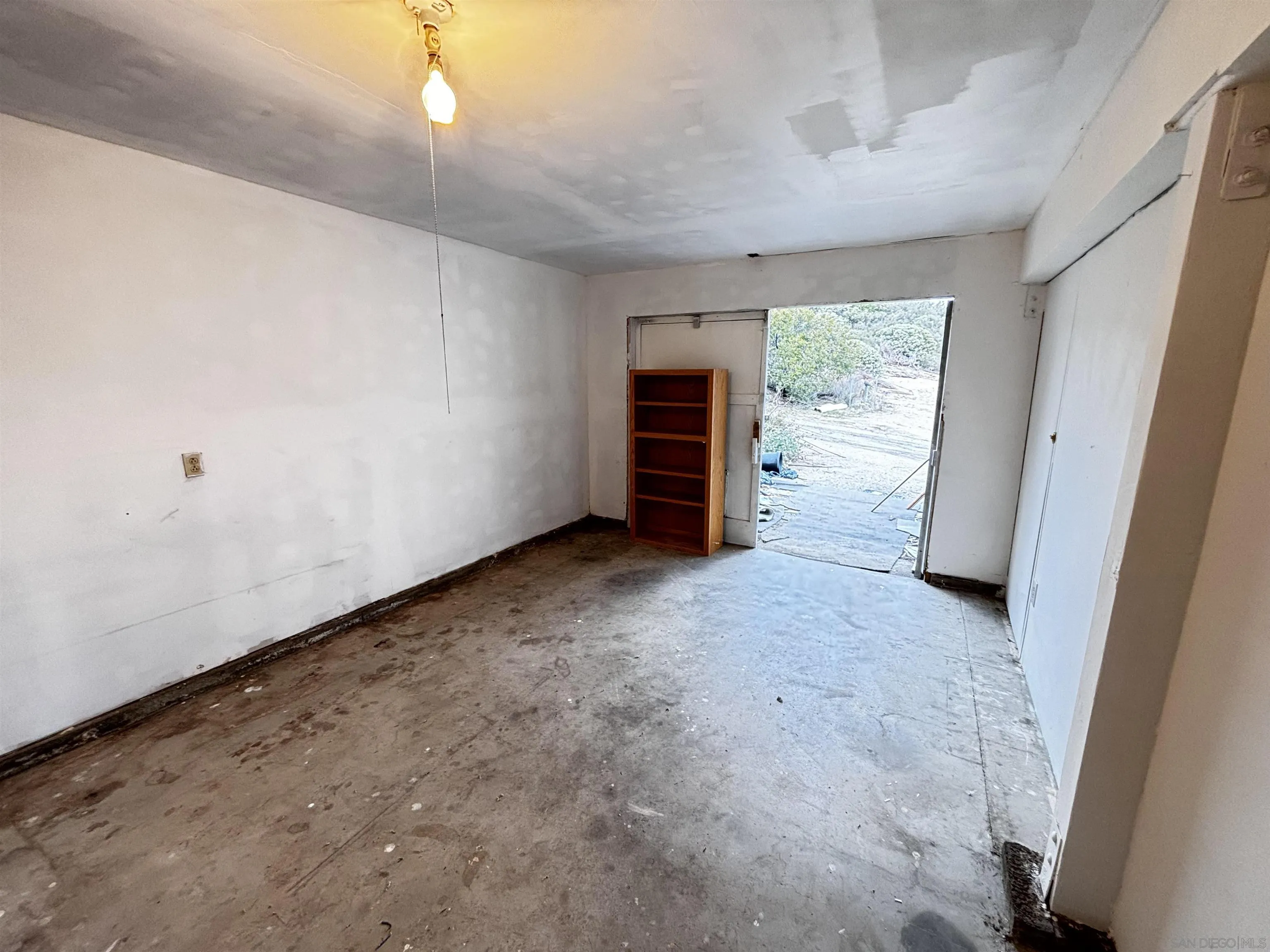 2602 La Posta Road Campo, CA 91906 - Photo 16 of 16 an empty room with a fireplace and painted walls