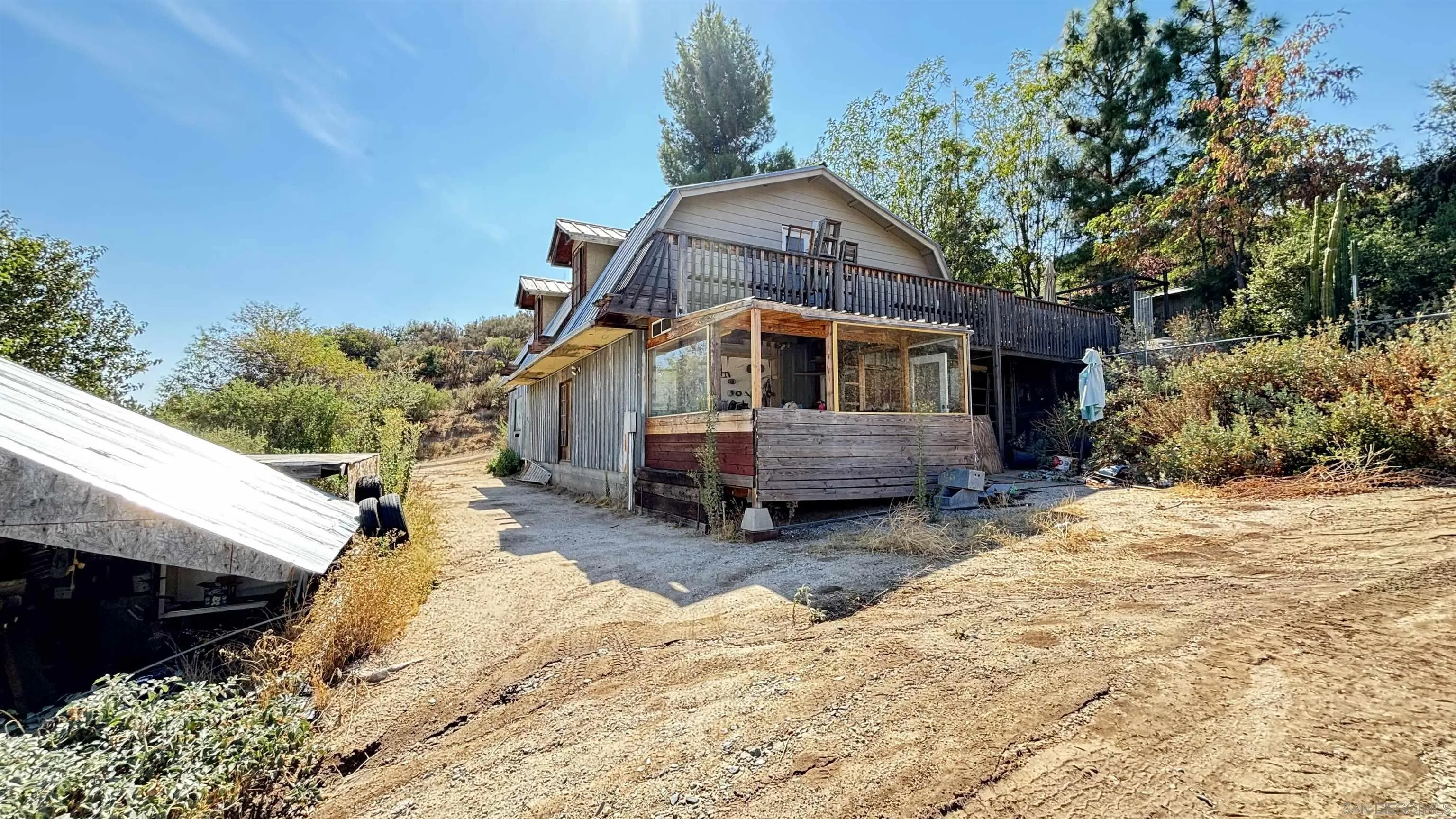 2602 La Posta Road Campo, CA 91906 - Photo 6 of 16 a tall house with a large tree in front of it
